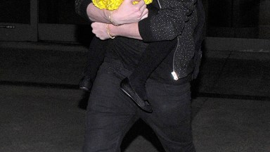 Brooklyn Beckham Carrying Harper Beckham