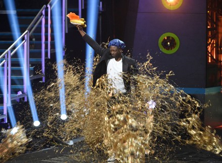 Dwayne Wade holds up the legend award as he is covered in gold slime at the Kids' Choice Sports Awards, at the Barker Hangar in Santa Monica, Calif
2019 Kids' Choice Sports Awards - Show, Santa Monica, USA - 11 Jul 2019