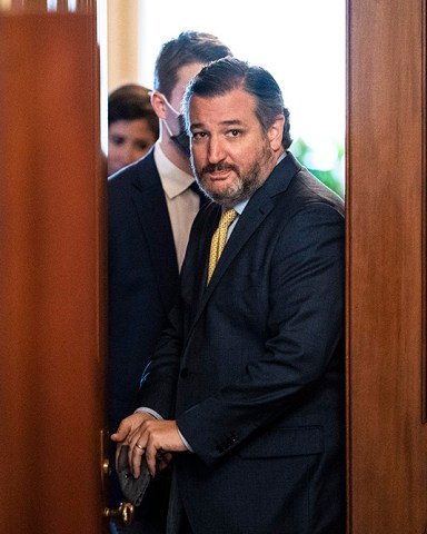 Sen. Ted Cruz, R-Texas, walks out of a meeting room for the lawyers of former President Donald Trump and back to the Senate floor through the Senate Reception room on the fourth day of the Senate Impeachment trials for former President Donald Trump on Capitol Hill, Friday, Feb 12, 2021 in Washington. (Jabin Botsford/The Washington Post via AP, Pool)