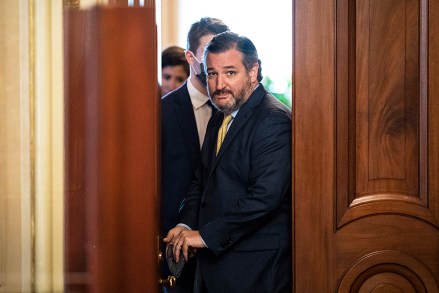 Sen. Ted Cruz, R-Texas, walks out of a meeting room for the lawyers of former President Donald Trump and back to the Senate floor through the Senate Reception room on the fourth day of the Senate Impeachment trials for former President Donald Trump on Capitol Hill, Friday, Feb 12, 2021 in Washington. (Jabin Botsford/The Washington Post via AP, Pool)