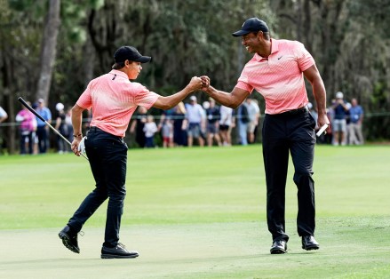 Tiger Woods, right and his son Charlie Woods, right, bump fists during the first round of the PNC Championship golf tournament, in Orlando, Fla
PNC Championship Golf, Orlando, United States - 17 Dec 2022