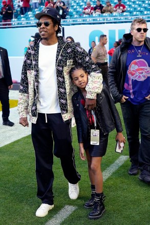 Entertainer Jay-Z walks with his daughter Blue Ivy Carter as they arrive for the NFL Super Bowl 54 football game between the San Francisco 49ers and the Kansas City Chiefs, Sunday, Feb.  2, 2020, in Miami.  (AP Photo / David J. Phillip)