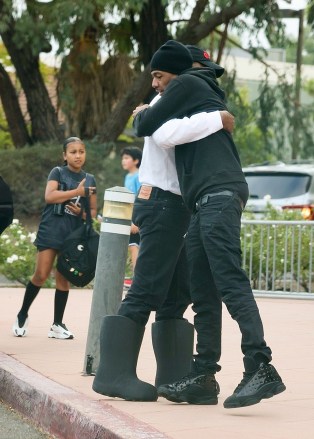 Thousand Oaks, CA - Kanye West is hugged by Nick Cannon as the two run into each other at their child's basketball game in Thousand Oaks.  Pictured: Kanye West, Nick Cannon, North West BACKGRID USA 14 OCTOBER 2022 USA: +1 310 798 9111 / usasales@backgrid.com UK: +44 208 344 2007 / uksales@backgrid.com *UK customers - please include pixel images Face before publication*