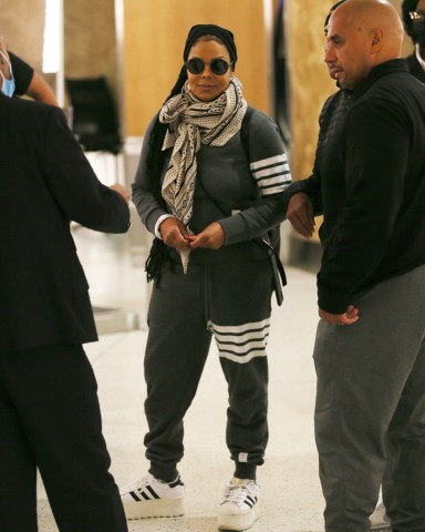 New York, NY  - *EXCLUSIVE*  - A smiling Janet Jackson is in good spirits as she flies out of JFK Airport in New York.  Pictured: Janet Jackson  BACKGRID USA 8 MAY 2022   BYLINE MUST READ: T.JACKSON / BACKGRID  USA: +1 310 798 9111 / usasales@backgrid.com  UK: +44 208 344 2007 / uksales@backgrid.com  *UK Clients - Pictures Containing Children Please Pixelate Face Prior To Publication*