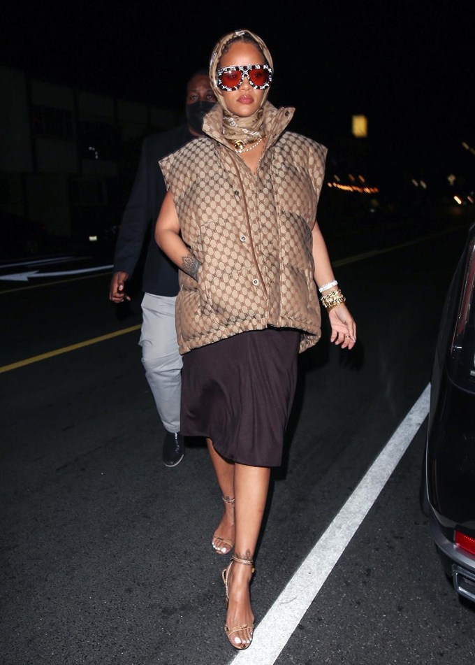 Rihanna Wears Brown Minidress, Louis Vuitton Bag, and Trucker Hat