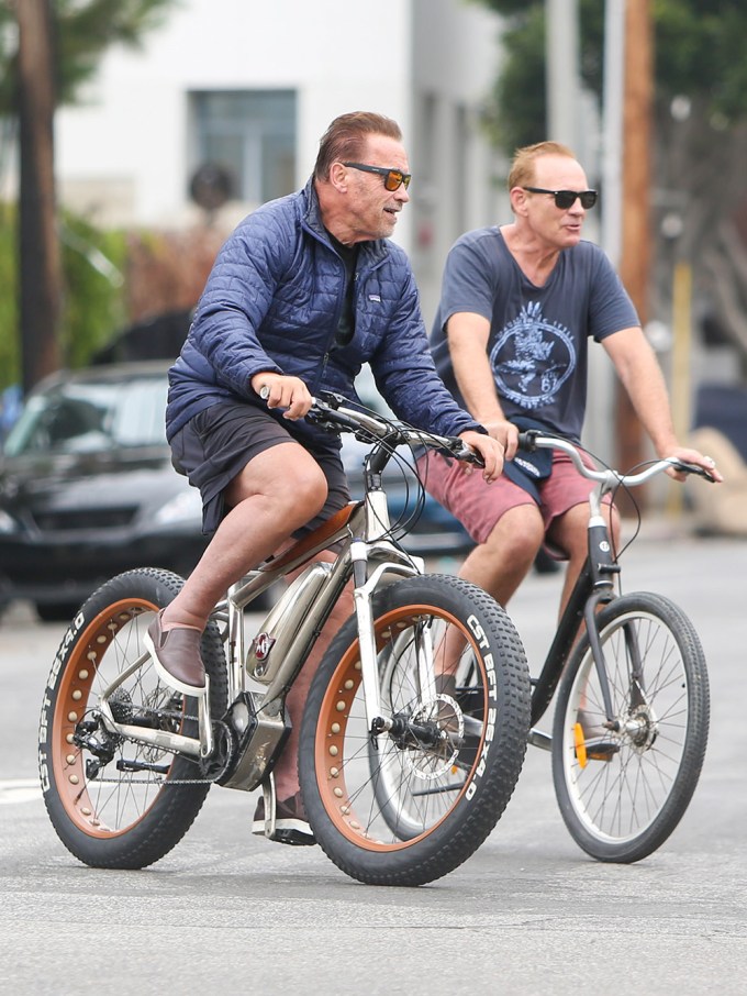 Arnold Schwarzenegger bike riding with a friend