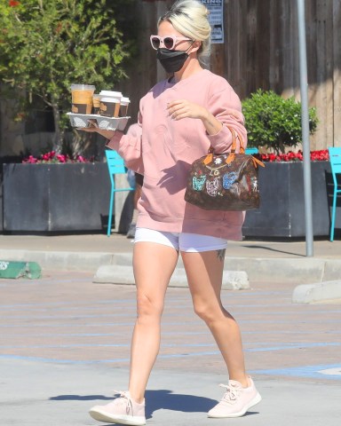 Malibu, CA  - *EXCLUSIVE*  - Lady Gaga looks great in white shorts and a pink sweatshirt with matching sunglasses as she stops at the Trancas Country Market to pick up coffee to go.  Pictured: Lady Gaga  BACKGRID USA 28 FEBRUARY 2022   BYLINE MUST READ: RMBI / BACKGRID  USA: +1 310 798 9111 / usasales@backgrid.com  UK: +44 208 344 2007 / uksales@backgrid.com  *UK Clients - Pictures Containing Children Please Pixelate Face Prior To Publication*