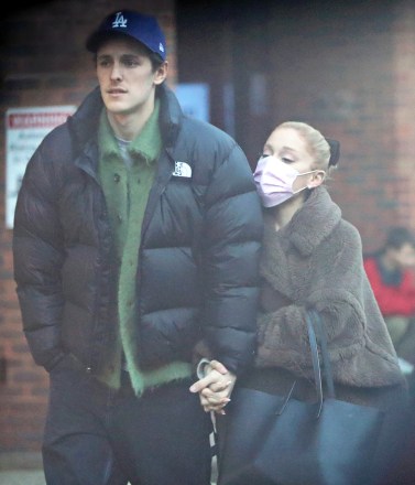 EXCLUSIVE: Ariana Grande and her husband Dalton Gomez indulge in Crepes from the famous La Creperie de Hampstead. The pint-sized pop star who is in the capital filming Wicked parts 1 & 2 looked adorable in an oversized coat, platform trainers, and a pink face mask that she removed to take some selfies near the popular stand that serves sweet and savoury french crêpes and has been a Hampstead favorite for many years. 23 Jan 2023 Pictured: Ariana Grande, Dalton Gomez. Photo credit: MEGA TheMegaAgency.com +1 888 505 6342 (Mega Agency TagID: MEGA939190_041.jpg) [Photo via Mega Agency]