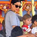 Kim Kardashian and her family enjoy a carousel ride at disneyland on North's 2nd birthday