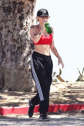 Hollywood, CA  - *EXCLUSIVE*  - Pop sensation/actress Miley Cyrus was spotted showing off her toned-up abs while hiking in the Hollywood Hills. Miley wore a red hot crop top, black cap, and Adidas track pants as she sipped on a bottle of water.Pictured: Miley CyrusBACKGRID USA 12 JUNE 2022 BYLINE MUST READ: BAMBAM / BACKGRIDUSA: +1 310 798 9111 / usasales@backgrid.comUK: +44 208 344 2007 / uksales@backgrid.com*UK Clients - Pictures Containing ChildrenPlease Pixelate Face Prior To Publication*