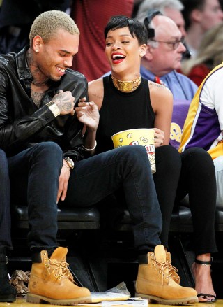 Singers Chris Brown, left, and Rihanna attend the New York Knicks playing against the Los Angeles Lakers NBA basketball game in Los Angeles, Tuesday, Dec. 25, 2012.  (AP Photo/Alex Gallardo)