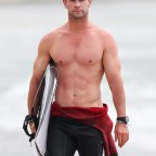 He Thor looks good! Chris Hemsworth flaunts his washboard abs after gone surfing in Byron Bay