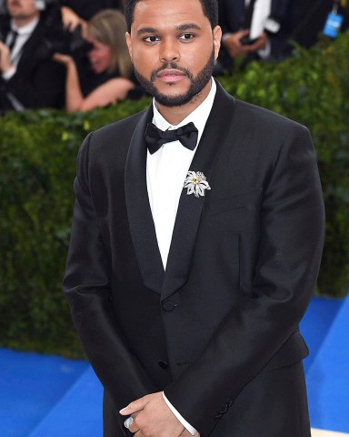 NOVEMBER 25th 2020: The Weeknd accuses the Grammy Awards and the Recording Academy of being corrupt after failing to receive Grammy Award nominations for his album "After Hours" or his single "Blinding Lights". He and his management team contend that because he had agreed to perform during the 2021 Superbowl - and could therefore not also perform during the Grammy Awards Show - he was excluded for consideration for any Grammy Awards. - File Photo by: zz/DP/AAD/STAR MAX/IPx 2017 5/1/17 The Weeknd at the 2017 Costume Institute Gala - "Rei Kawakubo/Comme des Garcons: Art Of The In-Between" held on May 1, 2017 at the Metropolitan Museum of Art in New York City. (NYC)