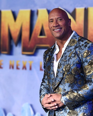 Cast member Dwayne Johnson poses for photographers at the Los Angeles premiere of "Jumanji: The Next Level," at the TCL Chinese Theatre, Monday, Dec. 9, 2019. (Photo by Jordan Strauss/Invision/AP)