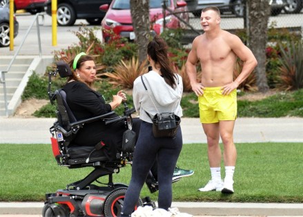 EXCLUSIVE: Dance Moms star Abby Lee Miller doesn’t flinch as a gymnast SOMERSAULTS over her during an outing to an LA beach. The reality TV star, 55, bravely lay back in her wheelchair as the muscular shirtless performer ran towards her then vaulted above her. Miller, who shot to fame as the star of hit show Dance Moms, has been using a wheelchair after undergoing surgery to remove a tumor from her spinal cord after reportedly being diagnosed with a form of cancer called Burkitt Lymphoma. Miller’s visit to the beach in Santa Monica, CA, saw her talking to a man and a woman dressed in workout gear before giving him a series of dance lessons. An onlooker said: “Abby was in great form and started giving the guy dance lessons. "She was teaching him to move and how and when to move his feet and it seemed he was struggling to get the hang of it. It was like she was back on the show Dance Moms and was shouting orders at him to ‘move to the side’ or ‘back right’. She appeared to be trying to teach him ballet just like she did to kids on the series. “It looked the guy had some gymnastic training and so afterwards they did a stunt where he ran at her and somersaulted directly above her.” Miller spent eight seasons on Dance Mom and previously taught Joelle Joanie “Jojo” Siwa. In 2017 she was sentenced to 366 days in prison for bankruptcy fraud. 31 Aug 2021 Pictured: Abbey Lee Miller . Photo credit: KAT/MEGA TheMegaAgency.com +1 888 505 6342 (Mega Agency TagID: MEGA782922_032.jpg) [Photo via Mega Agency]