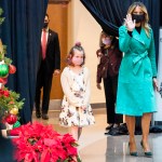 First lady Melania Trump arrives to read a Christmas story with Sofia Martinez, 8, left, and Riley Whitney, 6, both children who are patients at Children's National Hospital, Tuesday, Dec. 15, 2020, during an annual event in Washington. Due to pandemic concerns there were two children in the room and the reading was broadcast to children in the rest of the hospital. (AP Photo/Jacquelyn Martin)