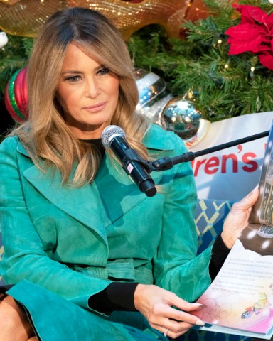 First lady Melania Trump reads a Christmas book titled, "Oliver the Ornament Meets Marley and Joan and Abbey," at Children's National Hospital, Tuesday, Dec. 15, 2020, in Washington. Due to pandemic concerns there were two children in the room and the reading was broadcast to children in the rest of the hospital. (AP Photo/Jacquelyn Martin)