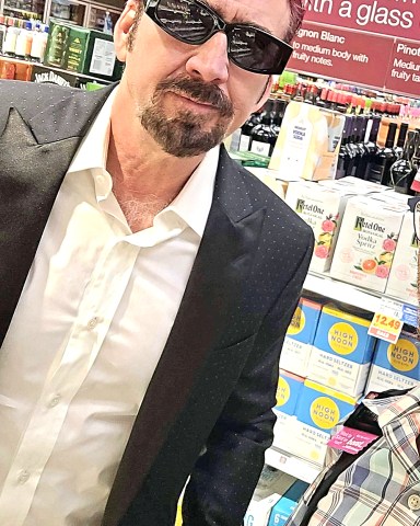 EXCLUSIVE: Nicolas Cage was spotted overdressed grocery shopping Saturday in Las Vegas, wearing a long sleeve white dress shirt with a black coat and sporting his new bright red hair. Hopefully, "The Leaving Las Vegas" star won't be leaving Vegas anytime soon. 20 Aug 2022 Pictured: Nicolas Cage with new red hair. Photo credit: TripleT / MEGA TheMegaAgency.com +1 888 505 6342 (Mega Agency TagID: MEGA888194_001.jpg) [Photo via Mega Agency]