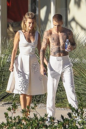 Hollywood, California – The fun continues for Justin Bieber and Hailey Baldwin as they don all white outfits for the next part of their photo shoot, which was a little reminiscent of wedding attire.  Between takes, Justin could be seen entertaining Hailey and the crew by playing his guitar.  Pictured: Justin Bieber, Hailey Baldwin BACKGRID USA DECEMBER 4, 2018 USA: +1 310 798 9111 / usasales@backgrid.com UK: +44 208 344 2007 / uksales@backgrid.com *UK customers please pixel contains.  Publication*