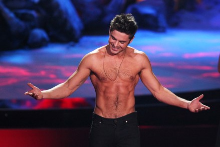 Zac Efron accepts the award for best shirtless performance for That Awkward Moment on stage at the MTV Movie Awards, at Nokia Theater in Los Angeles 2014 MTV Movie Awards - Show, Los Angeles, USA - 13 Apr 2014