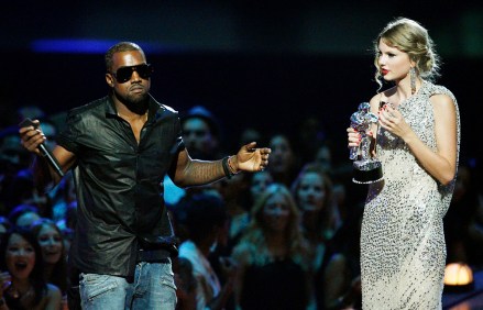 Singer Kanye West takes the microphone from singer Taylor Swift as