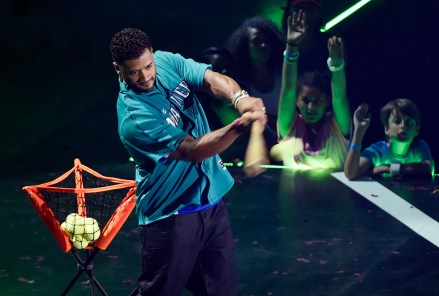 Host Russell Wilson hits a ball out into the crowd during the 2016 Kids' Choice Sports Awards at Pauley Pavilion, in Los Angeles
2016 Kids' Choice Sports Awards - Show, Los Angeles, USA - 14 Jul 2016