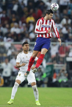 Atletico Madrid's Alvaro Morata, top, heads the ball past Real Madrid's Casemiro during the Spanish Super Cup Final soccer match between Real Madrid and Atletico Madrid at King Abdullah stadium in Jiddah, Saudi Arabia
Saudi Spanish Super Cup Soccer, Jiddah, Saudi Arabia - 12 Jan 2020