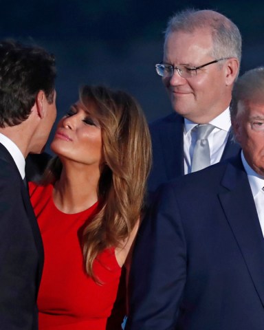Canadian Prime Minister Justin Trudeau (L) hugs US First Lady Melania Trump (2-L) as US President Donald J. Trump (R) and Australian Prime Minister Scott Morrison (2-R)  looks on as they attend the family photo during the G7 summit at Casino in Biarritz, France, 25 August 2019. The G7 Summit runs from 24 to 26 August in Biarritz.
G7 Summit Biarritz in France, Bayonne - 25 Aug 2019