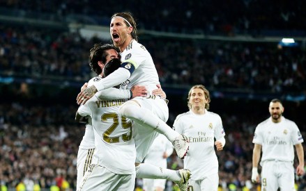 Real Madrid's Isco, left, celebrates with teammates after scoring his side's opening goal during the Champions League, round of 16, first leg soccer match between Real Madrid and Manchester City at the Santiago Bernabeu stadium in Madrid, Spain
Soccer Champions League, Madrid, Spain - 26 Feb 2020