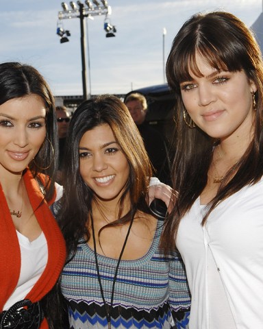 From left, television personalities Kim, Kourtney and Khloe Kardashian participate in the 2nd Annual DirecTV Celebrity Beach Bowl presented by Spike, Thursday, Jan. 31, 2008 in Scottsdale, Ariz. (AP Photo/Evan Agostini)