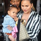John Legend and Chrissy Teigen get mobbed by the paparazzi as they and their daughter leave Il Pistaio Restaurant in Beverly Hills, Ca