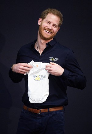 Prince Harry is given a babygrow for his new son during the Invictus Games presentation
Prince Harry visit to The Hague, Netherlands - 09 May 2019