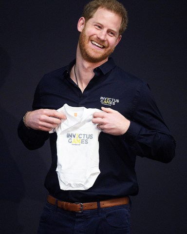 Prince Harry is given a babygrow for his new son during the Invictus Games presentation
Prince Harry visit to The Hague, Netherlands - 09 May 2019