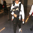Angela Simmons totes her newborn while departing LAX