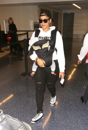 AG_175249 - - Los Angeles, CA - Angela Simmons holds her newborn son Sutton as she departs LAX.  Angela looks casual in sunglasses, a backwards hat, a white hoodie, black leggings and white sneakers.  Image: Angela Simmons, Sutton Joseph Tennyson AKM-GSI March 3, 2017 Byline Must Read: Shotgator / AKM-GSI Maria Buda (917) 242-1505 mbuda@akmgsi.com Mark Satter (317) 691-9592 msatter@akmgsi.com OR sales@akmgsi.com