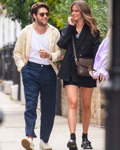 London, UNITED KINGDOM  - *EXCLUSIVE*  - 1D star Niall Horan looks loved up with girlfriend Amelia as he takes her dad and mum out for Fathers Day lunch. The pair looked happy as they strolled arm in arm through Knightsbridge with her mum and dad and friend to Hawksmoor restaurant. Two surprised women did a double-take as they recognized the One Direction heartthrob. Niall wearing a £430 linen Bode shirt adorned with yachts and Navy linen trousers with white detailing, Amelia was dressed in a black blazer and black mini skirt with a Louis Vuitton bag and Sandro iron platform loafers priced £345. Amelia who left the restaurant with her parents first was seen posing up against a large door for a photo whilst waiting for Niall who was last to leave. The couple has been dating for 2 years and is said to be serious.

Pictured: Niall Horan Amelia Woolley Paul Woolley

BACKGRID USA 20 JUNE 2022 

USA: +1 310 798 9111 / usasales@backgrid.com

UK: +44 208 344 2007 / uksales@backgrid.com

*UK Clients - Pictures Containing Children
Please Pixelate Face Prior To Publication*
