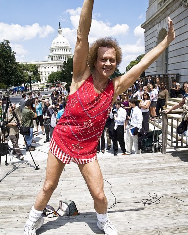 Richard Simmons leads a group of Capitol Hill staffers and tourists in an exercise routine.
Exercise Guru, Richard Simmons promoting programmes to fight obesity, Washington DC, America - 24 Jul 2008
American fitness guru Richard Simmons brought his own brand of fitness to Washington after testifying before the House Education Committee on childhood obesity. The 60-year-old would like to see the government doing more to tackle the issue of childhood obesity and is also pushing for increased school exercise programs. "Our children today will not live as long as their parents. What have we done? What have we done to the kids of the United States of America! This is wrong! And I will dedicate the rest of my life!" he said; adding that not everyone can be an athlete but everyone can be fit, he said schools need to hire certified fitness instructors. While giving his testimony Simmons, who hinted that he may even run for office, was dressed in a smart black suit. However, he then quickly changed into a more familiar outfit of tiny striped shorts and red top to give an impromptu fitness session outside.