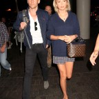 Taylor Swift & Tom Hiddleston continue their world tour as they fly out of Los Angeles surrounded by several bodyguards.  The "1989" singer & "The Avengers" actor were seen side by side as they caught a flight out of LAX.
