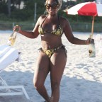 Singer Mary J. Blige looks amazing in a black and gold bikini as she soaks up the sun in Miami