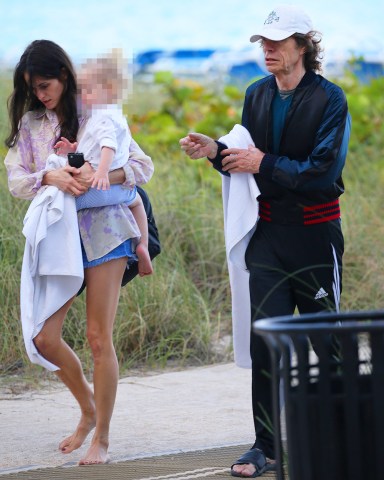 EXCLUSIVE: Mick Jagger and partner Melanie Hamrick walk along the beach with their son Deveraux in Miami. 31 Mar 2019 Pictured: Mick Jagger; Melanie Hamrick. Photo credit: MEGA TheMegaAgency.com +1 888 505 6342 (Mega Agency TagID: MEGA392115_001.jpg) [Photo via Mega Agency]