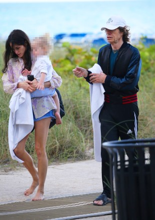 EXCLUSIVE: Mick Jagger and his partner Melanie Hamrick walk along the beach with their son Deveraux in Miami.  31 March 2019 Pictured: Mick Jagger;  Melanie Hamrick.  Photo credit: MEGA TheMegaAgency.com +1 888 505 6342 (Mega Agency TagID: MEGA392115_001.jpg) [Photo via Mega Agency]
