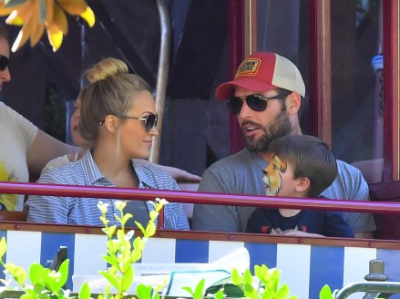 EXCLUSIVE: Pregnant Carrie Underwood and her husband, Mike Fisher take their son Isaiah, 3, on his first trip to Disneyland. The happy family, joined by one VIP tour guide as well as their own bodyguard, are seen enjoying many of the park's rides and attractions. Carrie stepped back and didn't ride too many of the rides possibly due to her pregnancy, but her son and husband enjoyed a rides in Cars Land, and the Pixar pier. They all enjoyed a ride on the train in Disneyland and a boat ride on It's a Small World. Carrie and her family also enjoyed snacks including some ice cream in Toon Town. The singer was not really noticed by fans on her Disney trip, however she did take a couple of selfies with a few fans that spotted her. The 35 year-old country music sensation revealed over the weekend that she endured three miscarriages in the last two years. 16 Sep 2018 Pictured: Carrie Underwood, Isaiah Fisher, Mike Fisher. Photo credit: Marksman/Snorlax / MEGA TheMegaAgency.com +1 888 505 6342 (Mega Agency TagID: MEGA276575_007.jpg) [Photo via Mega Agency]