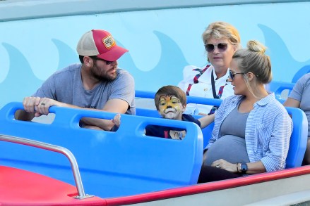 EXCLUSIVE: Pregnant Carrie Underwood and her husband, Mike Fisher take their son Isaiah, 3, on his first trip to Disneyland. The happy family, joined by one VIP tour guide as well as their own bodyguard, are seen enjoying many of the park's rides and attractions. Carrie stepped back and didn't ride too many of the rides possibly due to her pregnancy, but her son and husband enjoyed a rides in Cars Land, and the Pixar pier. They all enjoyed a ride on the train in Disneyland and a boat ride on It's a Small World. Carrie and her family also enjoyed snacks including some ice cream in Toon Town. The singer was not really noticed by fans on her Disney trip, however she did take a couple of selfies with a few fans that spotted her. The 35 year-old country music sensation revealed over the weekend that she endured three miscarriages in the last two years. 16 Sep 2018 Pictured: Carrie Underwood, Isaiah Fisher, Mike Fisher. Photo credit: Marksman/Snorlax / MEGA TheMegaAgency.com +1 888 505 6342 (Mega Agency TagID: MEGA276575_022.jpg) [Photo via Mega Agency]