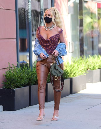 EXCLUSIVE: Iggy Azalea was spotted out in Beverly Hills on Wednesday evening, as she made a stop for Frozen Greek Yogurt . The stylish rapper wore a Vivienne Westwood Corset, and Jacket along with a Bold Christian Dior Statement necklace . She wore a black face mask to stay safe , and carried a Dior Saddle bag , to complete her stylish look. She took to instagram today to deny any involvement in a lawsuit directed at French Montana's Brother, who hit a man with a car that belonged to Azalea. 22 Jul 2020 Pictured: Iggy Azalea. Photo credit: MEGA TheMegaAgency.com +1 888 505 6342 (Mega Agency TagID: MEGA690320_001.jpg) [Photo via Mega Agency]