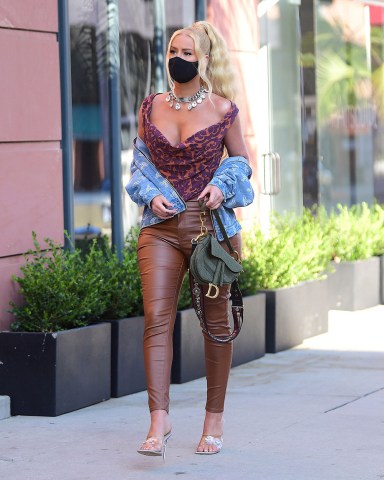 EXCLUSIVE: Iggy Azalea was spotted out in Beverly Hills on Wednesday evening, as she made a stop for Frozen Greek Yogurt . The stylish rapper wore a Vivienne Westwood Corset, and Jacket along with a Bold Christian Dior Statement necklace . She wore a black face mask to stay safe , and carried a Dior Saddle bag , to complete her stylish look. She took to instagram today to deny any involvement in a lawsuit directed at French Montana's Brother, who hit a man with a car that belonged to Azalea. 22 Jul 2020 Pictured: Iggy Azalea. Photo credit: MEGA TheMegaAgency.com +1 888 505 6342 (Mega Agency TagID: MEGA690320_001.jpg) [Photo via Mega Agency]