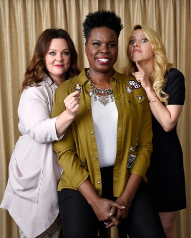 Melissa McCarthy, left, Leslie Jones, center, and Kate McKinnon, cast members in "Ghostbusters," pose with a Lego toy figure of fellow cast member Kristen Wiig during a portrait session at the Four Seasons Hotel in Los Angeles. Their film will be released on Friday
"Ghostbusters" Portrait Session, Los Angeles, USA