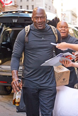 Michael Jordan carries a bottle of Tequila and a pillow as he leaves his hotel in New York Pictured: Michael Jordan Ref: SPL5003626 140618 NON EXCLUSIVE Photo By: Edward Opi / SplashNews.com Splash News and Pictures Los Angeles: 310-821 -2666 New York: 212-619-2666 London: 0207 644 7656 Milan: +39 02 4399 8577 photodesk@splashnews.com Global Rights