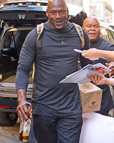 Michael Jordan carries a Tequila bottle and pillow while checking out of his hotel in New York City  Pictured: Michael Jordan Ref: SPL5003626 140618 NON-EXCLUSIVE Picture by: Edward Opi / SplashNews.com  Splash News and Pictures Los Angeles: 310-821-2666 New York: 212-619-2666 London: 0207 644 7656 Milan: +39 02 4399 8577 photodesk@splashnews.com  World Rights