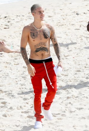Photos March 29,2017 Shirtless Justin Bieber drives fans wild as he shows off new lion and bear chest tattoos on Rio's famous Ipanema beach.he pop star is in Brazil as part of his tour and created chaotic scenes as he strolled on the beach across from his luxury hotel. He was surrounded by his security team and dozens of fans who had been camping outside. According to local reports police want him over graffiti he drew last time he was in the city.Pictured: Justin BieberRef: SPL1470996 300317 Picture by: Leo Marinho / Splash NewsSplash News and PicturesLos Angeles:310-821-2666New York:212-619-2666London:870-934-2666photodesk@splashnews.com