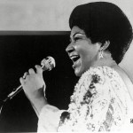 ARETHA FRANKLIN Vocalist Aretha Franklin warbles a few notes into microphone in photo
ARETHA FRANKLIN, USA